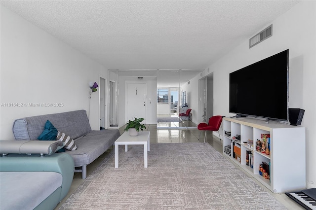 251 174th St Unit 2115, Sunny Isles Beach, FL 33160 - living area featuring a textured ceiling and tile patterned flooring