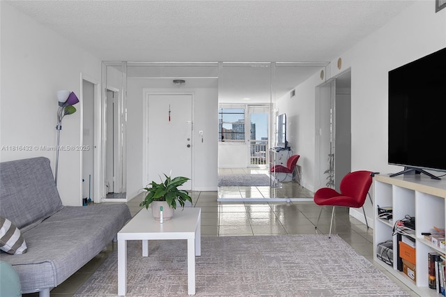 251 174th St Unit 2115, Sunny Isles Beach, FL 33160 - tiled living area featuring a textured ceiling