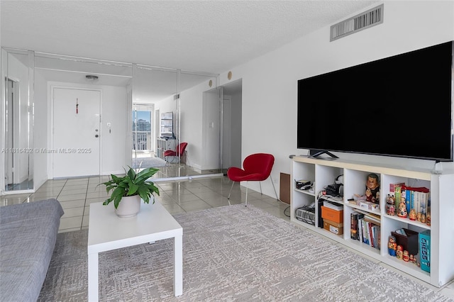 251 174th St Unit 2115, Sunny Isles Beach, FL 33160 - living area with a textured ceiling and tile patterned flooring