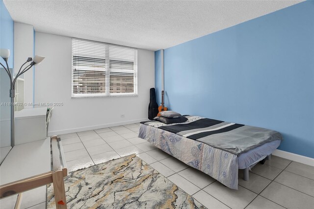 251 174th St Unit 2115, Sunny Isles Beach, FL 33160 - tiled bedroom with a textured ceiling and baseboards