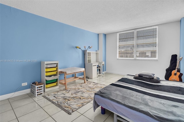 251 174th St Unit 2115, Sunny Isles Beach, FL 33160 - bedroom featuring a textured ceiling, baseboards, and light tile patterned floors