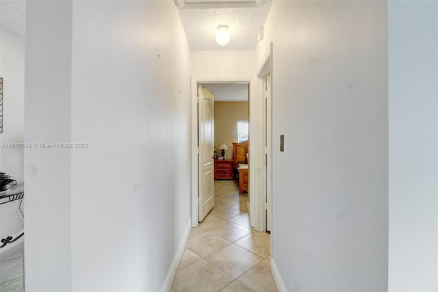 6710 SW 33rd St, Miami, FL 33155 - hall featuring a textured ceiling, light tile patterned flooring, attic access, and baseboards