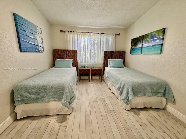 729 NW 47th St, Deerfield Beach, FL 33064 - bedroom with hardwood / wood-style flooring, a textured ceiling, a textured wall, and baseboards