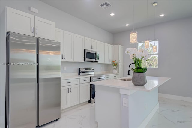 3121 71st St W, Lehigh Acres, FL 33971 - kitchen featuring appliances with stainless steel finishes, light marble finish floors, a sink, a kitchen island with sink, and baseboards