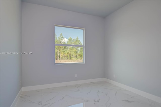 3121 71st St W, Lehigh Acres, FL 33971 - spare room featuring baseboards and marble look tiles