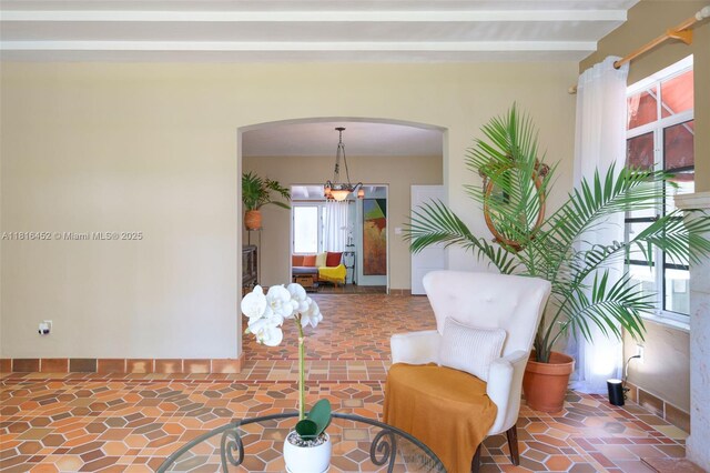 492 NE 55th St, Miami, FL 33137 - living area featuring arched walkways and a chandelier