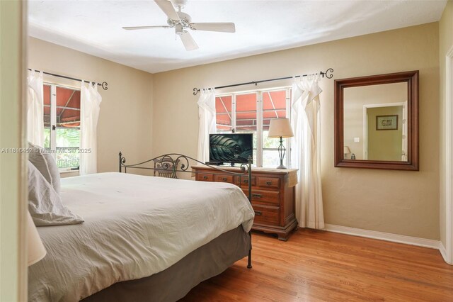 492 NE 55th St, Miami, FL 33137 - bedroom featuring multiple windows, wood finished floors, baseboards, and ceiling fan