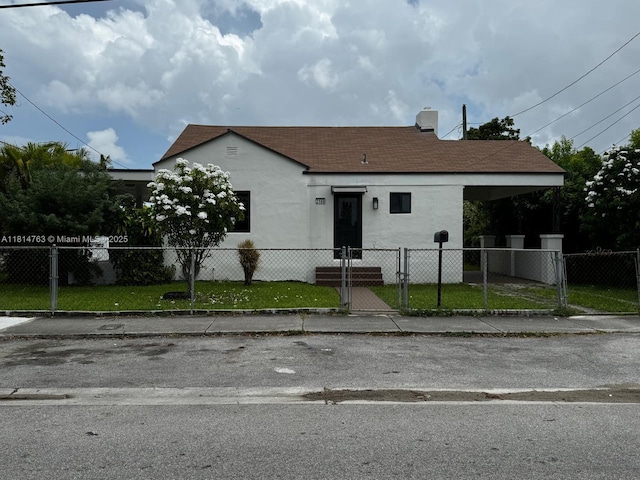 2160 NW 30th St, Miami, FL 33142 - bungalow with a fenced front yard, a shingled roof, stucco siding, and a gate