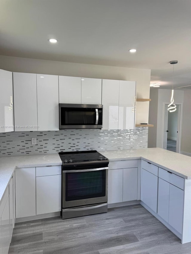 2160 NW 30th St, Miami, FL 33142 - kitchen with appliances with stainless steel finishes, white cabinetry, modern cabinets, light countertops, and recessed lighting