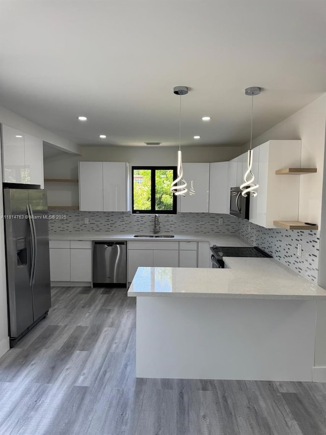 2160 NW 30th St, Miami, FL 33142 - kitchen with stainless steel appliances, open shelves, modern cabinets, white cabinets, and decorative light fixtures