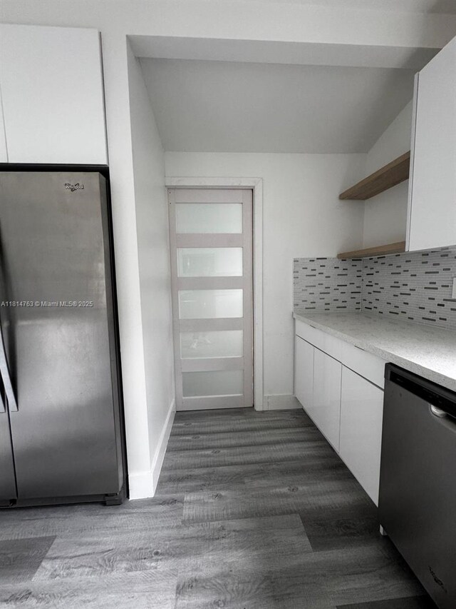 2160 NW 30th St, Miami, FL 33142 - kitchen with appliances with stainless steel finishes, open shelves, dark wood finished floors, white cabinets, and tasteful backsplash