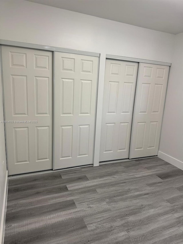 2160 NW 30th St, Miami, FL 33142 - unfurnished bedroom with wood finished floors and multiple closets
