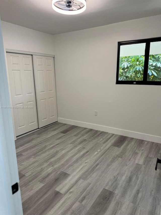 2160 NW 30th St, Miami, FL 33142 - unfurnished bedroom with wood finished floors and a closet