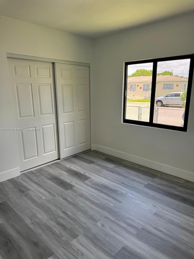 2160 NW 30th St, Miami, FL 33142 - unfurnished bedroom with wood finished floors and a closet