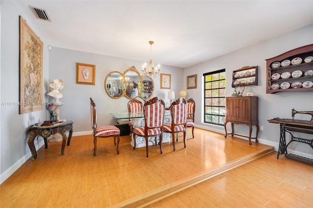 9728 SW 135th Ter, Miami, FL 33176 - dining room with wood finished floors, a chandelier, and baseboards