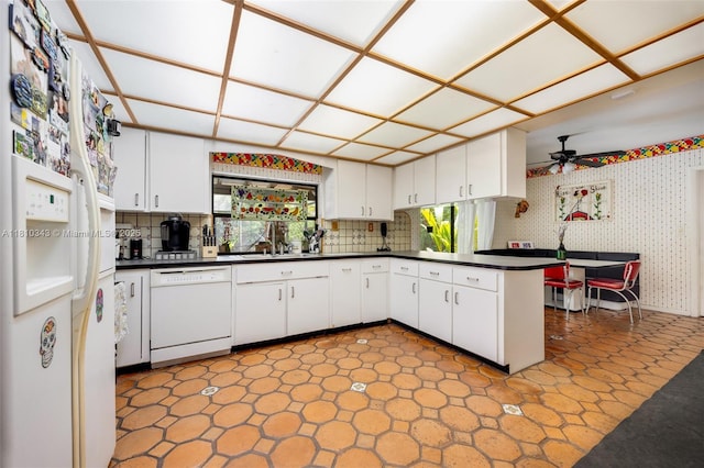 9728 SW 135th Ter, Miami, FL 33176 - kitchen featuring white appliances, dark countertops, ceiling fan, a peninsula, and white cabinetry