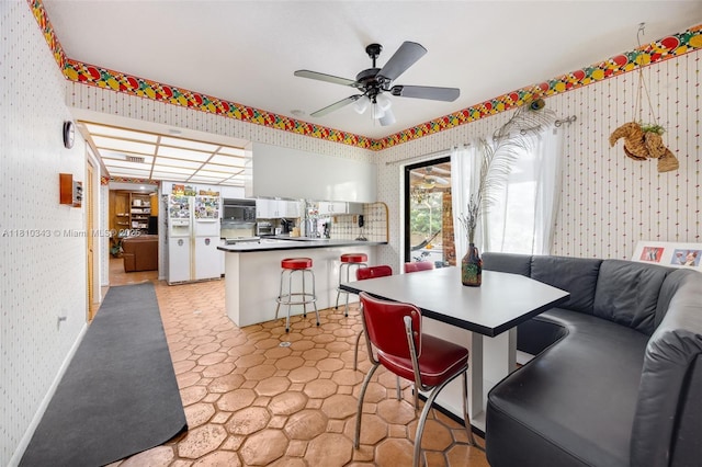 9728 SW 135th Ter, Miami, FL 33176 - dining space featuring wallpapered walls, a ceiling fan, and light flooring