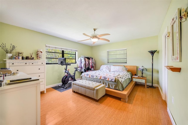 9728 SW 135th Ter, Miami, FL 33176 - bedroom featuring baseboards, light wood-type flooring, and a ceiling fan