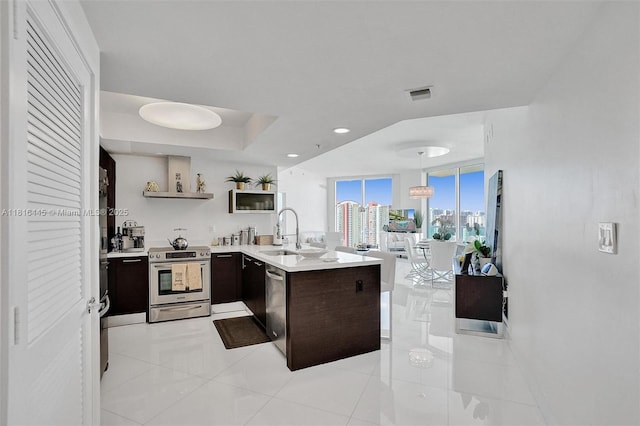 150 Sunny Isles Blvd Unit 1-1803, Sunny Isles Beach, FL 33160 - kitchen with stainless steel appliances, a sink, open shelves, light countertops, and recessed lighting