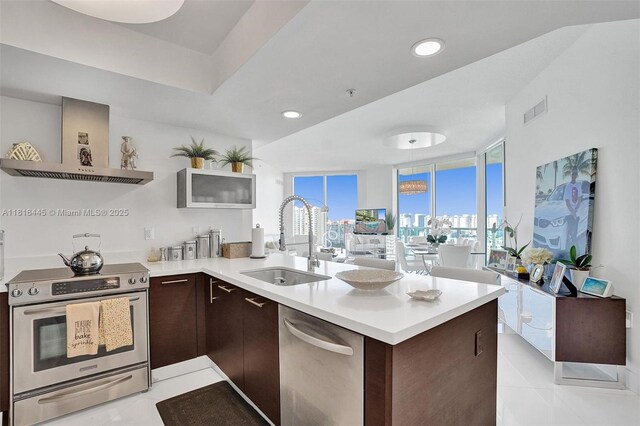 150 Sunny Isles Blvd Unit 1-1803, Sunny Isles Beach, FL 33160 - kitchen featuring a sink, appliances with stainless steel finishes, dark brown cabinets, and light countertops