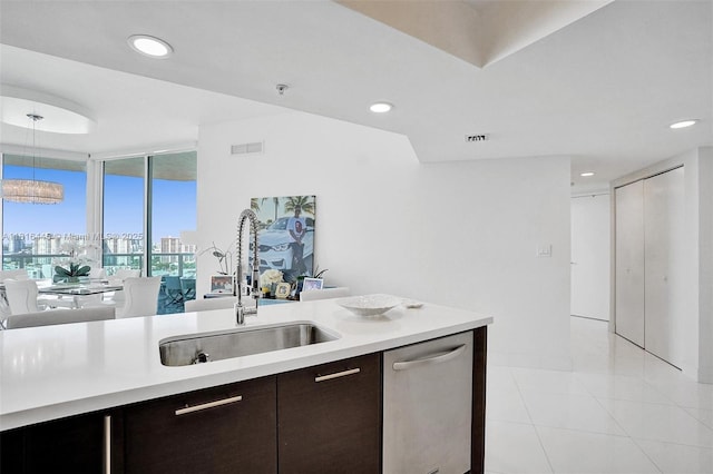 150 Sunny Isles Blvd Unit 1-1803, Sunny Isles Beach, FL 33160 - kitchen featuring a sink, stainless steel dishwasher, light countertops, light tile patterned flooring, and dark brown cabinetry