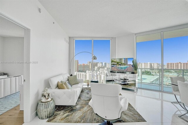 150 Sunny Isles Blvd Unit 1-1803, Sunny Isles Beach, FL 33160 - living room with expansive windows, healthy amount of natural light, and a textured ceiling