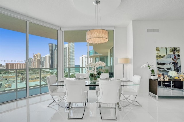150 Sunny Isles Blvd Unit 1-1803, Sunny Isles Beach, FL 33160 - dining room with floor to ceiling windows, tile patterned flooring, a view of skyline, and a textured ceiling
