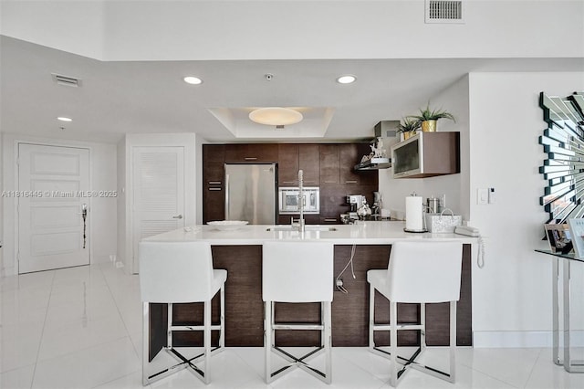 150 Sunny Isles Blvd Unit 1-1803, Sunny Isles Beach, FL 33160 - kitchen with stainless steel refrigerator, a peninsula, a sink, a breakfast bar area, and recessed lighting