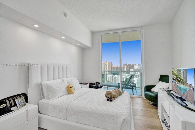 150 Sunny Isles Blvd Unit 1-1803, Sunny Isles Beach, FL 33160 - bedroom featuring multiple windows, access to outside, light wood-style floors, recessed lighting, and a wall of windows