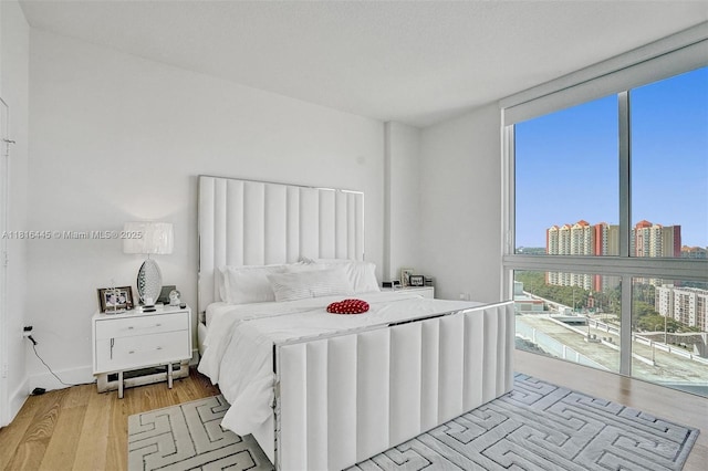 150 Sunny Isles Blvd Unit 1-1803, Sunny Isles Beach, FL 33160 - bedroom featuring light wood-type flooring and a view of city