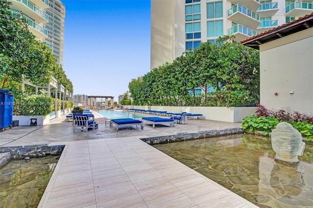 150 Sunny Isles Blvd Unit 1-1803, Sunny Isles Beach, FL 33160 - community pool featuring a patio
