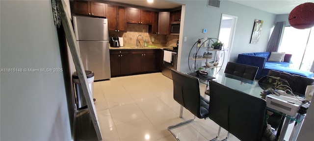 5773 Washington St Unit J2, Hollywood, FL 33023 - kitchen featuring appliances with stainless steel finishes, backsplash, and a sink