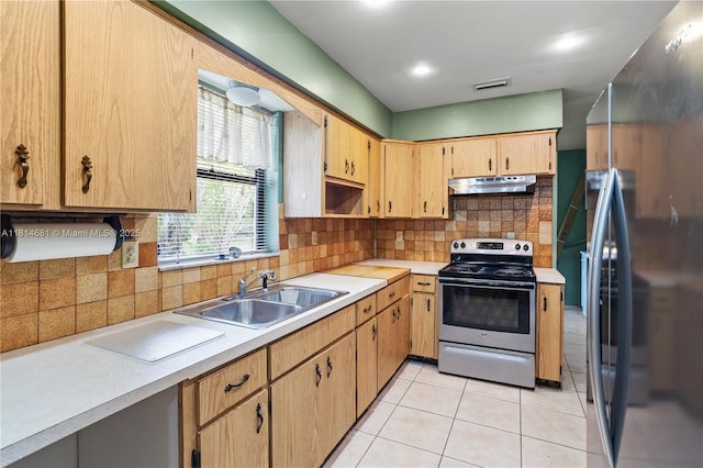4878 NW 2nd Ct, Plantation, FL 33317 - kitchen featuring stainless steel appliances, a sink, under cabinet range hood, light countertops, and backsplash