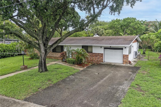 4878 NW 2nd Ct, Plantation, FL 33317 - ranch-style house with an attached garage, brick siding, asphalt driveway, a front yard, and roof with shingles