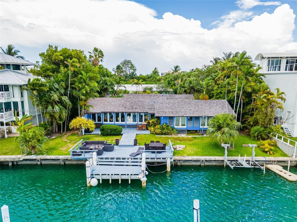 699 N Mashta Dr, Key Biscayne, FL 33149 - back of property with a water view and a lawn