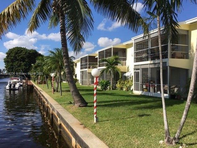 1100 Pine Dr Unit 106, Pompano Beach, FL 33060 - dock with a yard and a water view