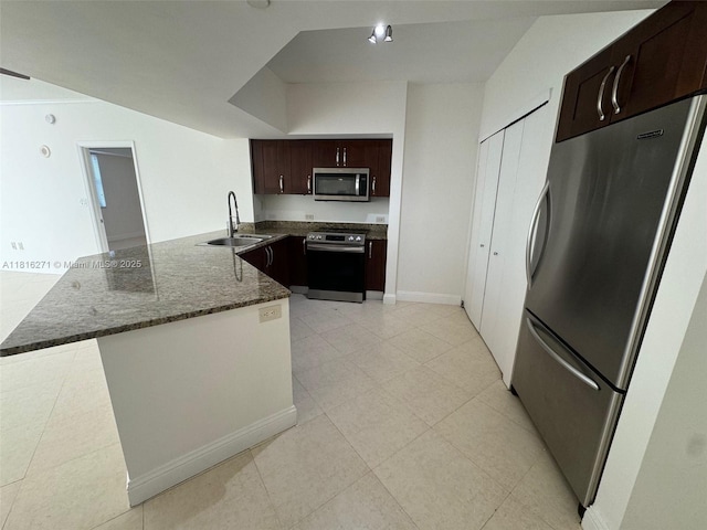 19900 E Country Club Dr Unit 209, Aventura, FL 33180 - kitchen with stainless steel appliances, a sink, a peninsula, dark brown cabinets, and dark stone countertops