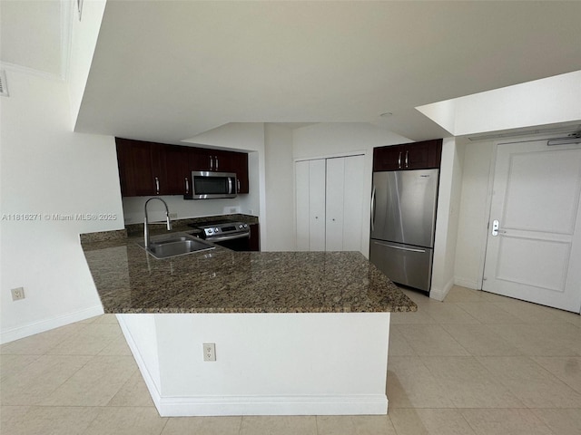 19900 E Country Club Dr Unit 209, Aventura, FL 33180 - kitchen featuring appliances with stainless steel finishes, a sink, dark brown cabinets, baseboards, and a peninsula