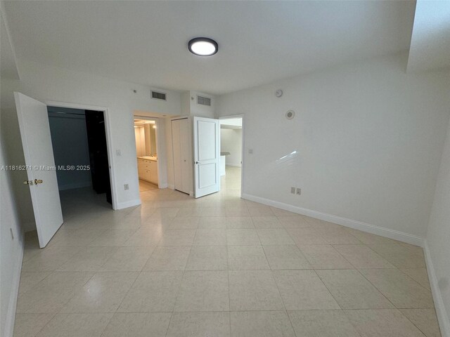 19900 E Country Club Dr Unit 209, Aventura, FL 33180 - unfurnished bedroom featuring baseboards, a spacious closet, and ensuite bathroom