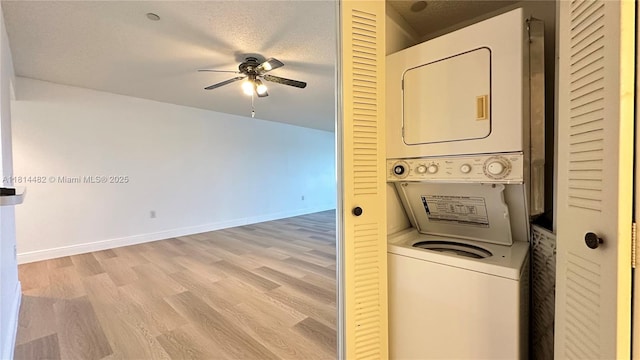 1351 SW 141st Ave Unit 407G, Pembroke Pines, FL 33027 - washroom with stacked washer and clothes dryer, a ceiling fan, light wood-style floors, and baseboards