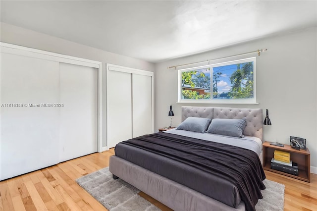 735 NE 38th St, Oakland Park, FL 33334 - bedroom featuring two closets and wood finished floors