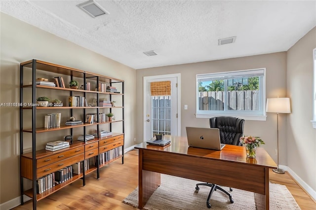 735 NE 38th St, Oakland Park, FL 33334 - office with light wood-type flooring, baseboards, and a textured ceiling