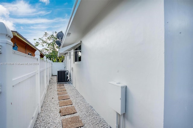 735 NE 38th St, Oakland Park, FL 33334 - view of side of home featuring central air condition unit and stucco siding