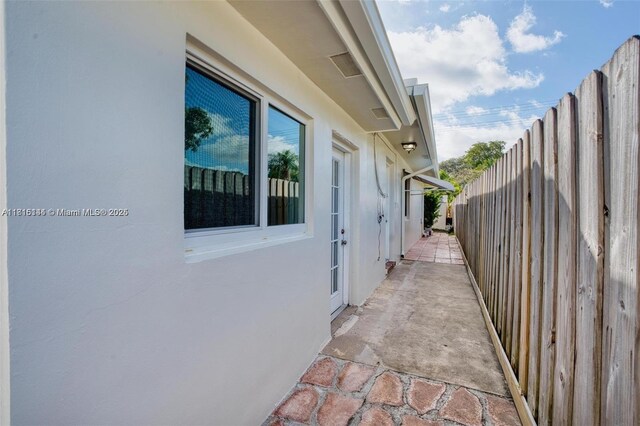 735 NE 38th St, Oakland Park, FL 33334 - view of side of property with stucco siding and a patio