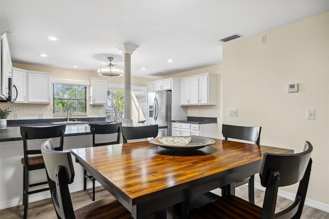4803 SW Santa Barbara Ct Unit 5, Cape Coral, FL 33914 - dining area with dark wood finished floors, ornate columns, and recessed lighting