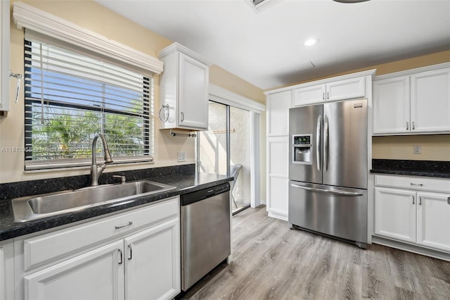 4803 SW Santa Barbara Ct Unit 5, Cape Coral, FL 33914 - kitchen featuring appliances with stainless steel finishes, white cabinetry, light wood-style floors, and recessed lighting