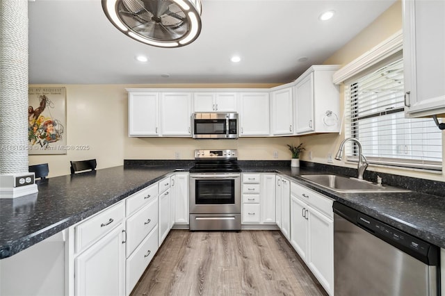 4803 SW Santa Barbara Ct Unit 5, Cape Coral, FL 33914 - kitchen featuring stainless steel appliances, white cabinets, light wood finished floors, recessed lighting, and a peninsula