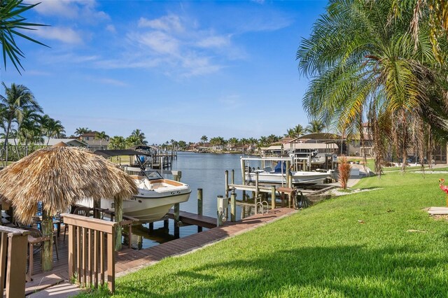 4803 SW Santa Barbara Ct Unit 5, Cape Coral, FL 33914 - dock with boat lift, a yard, and a water view