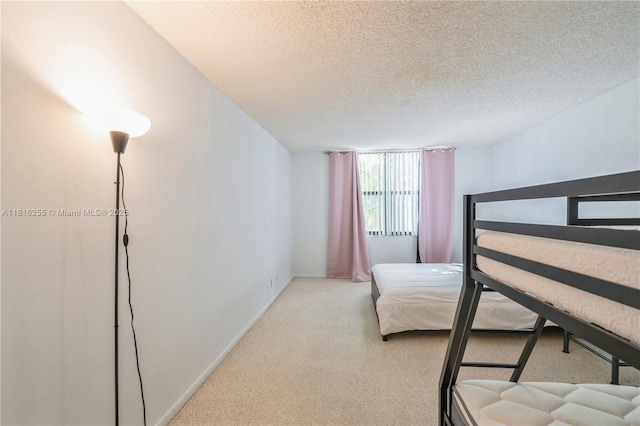 18151 NE 31st Ct Unit 205, Aventura, FL 33160 - carpeted bedroom featuring a textured ceiling and baseboards