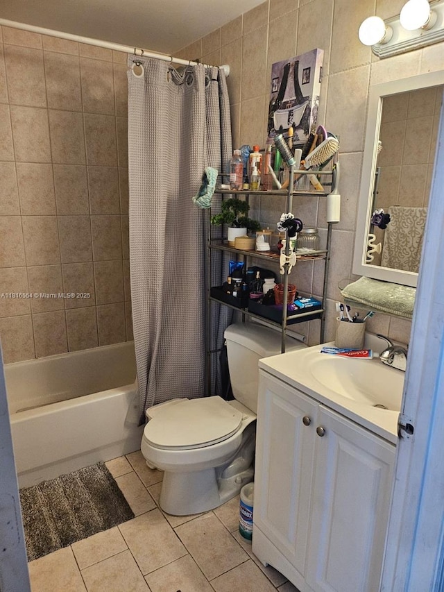 110 SE 2nd St Unit 210, Hallandale Beach, FL 33009 - bathroom featuring toilet, tile patterned floors, shower / bath combo with shower curtain, vanity, and tile walls